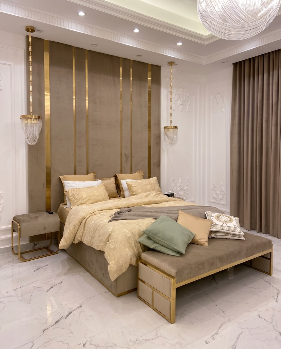 After: A bedroom suite, recomposed into a clean wide shot built around the brass and velvet headboard wall.